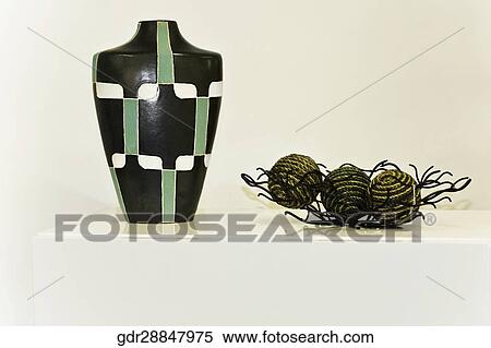 Stock Photography - Decorative urn and decorative balls on a table. Fotosearch