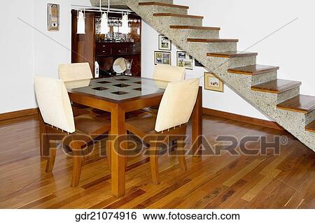 Dining table near a staircase View Large Photo Image Stock Photograph - Dining table near a staircase. Fotosearch