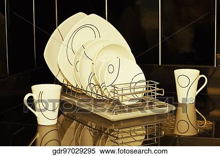 Dish rack on a kitchen counter View Large Photo Image Stock Photography - Dish rack on a kitchen counter. Fotosearch