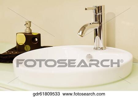 Faucet on a bathroom sink View Large Photo Image Stock Image - Faucet on a bathroom sink. Fotosearch