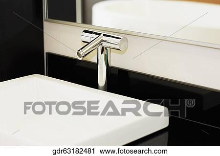 Faucet on a bathroom sink View Large Photo Image Stock Image - Faucet on a bathroom sink. Fotosearch