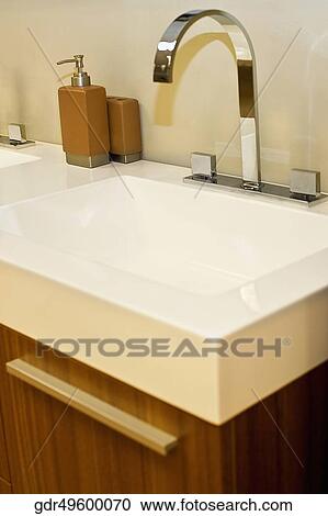 Stock Image - Faucet on a wash bowl in the bathroom. Fotosearch
