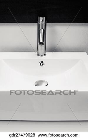 Faucet on a wash bowl in the bathroom View Large Photo Image Stock Photo - Faucet on a wash bowl in the bathroom. Fotosearch