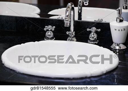 Faucet on a wash bowl View Large Photo Image Stock Photography - Faucet on a wash bowl. Fotosearch