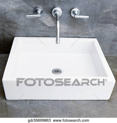 Stock Image - Faucets over a washbasin. Fotosearch