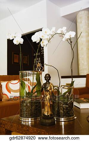 Flower vases and a figurine in a living room View Large Photo Image Stock Image - Flower vases and a figurine in a living room. Fotosearch