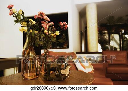 Flower vases and figurines in a living room View Large Photo Image Stock Image - Flower vases and figurines in a living room. Fotosearch