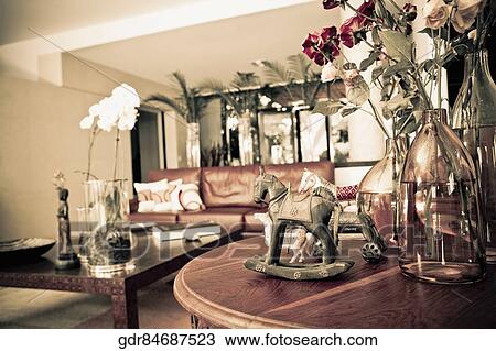Stock Image - Flower vases and figurines in a living room. Fotosearch