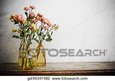 Flower vases with rose flowers on a sideboard View Large Photo Image Stock Image - Flower vases with rose flowers on a sideboard. Fotosearch