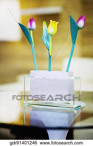 Flowers on a table in a living room View Large Photo Image Stock Photograph - Flowers on a table in a living room. Fotosearch