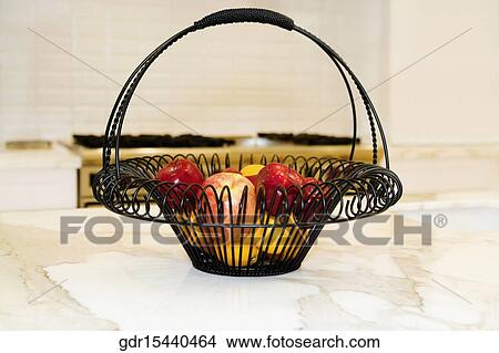 Fruits in a basket on a kitchen counter View Large Photo Image Picture - Fruits in a basket on a kitchen counter. Fotosearch
