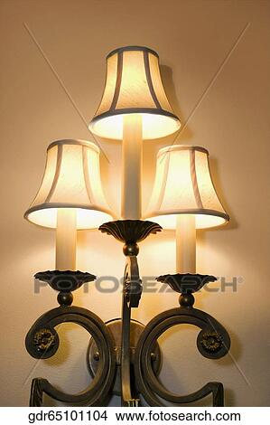 Illuminated lamp mounted on the wall View Large Photo Image Picture - Illuminated lamp mounted on the wall. Fotosearch