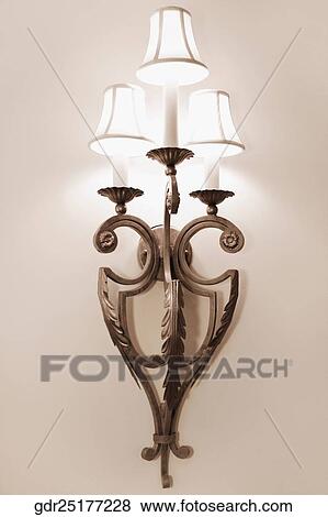 Stock Photo - Illuminated lamp mounted on the wall. Fotosearch