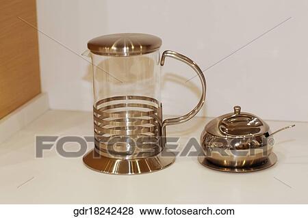 Jug with a sugar container on a kitchen counter View Large Photo Image Stock Photo - Jug with a sugar container on a kitchen counter. Fotosearch
