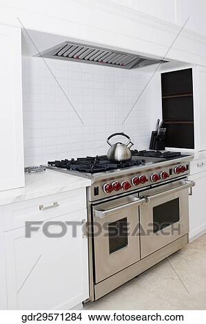 Kettle on a stove in a kitchen View Large Photo Image Picture - Kettle on a stove in a kitchen. Fotosearch