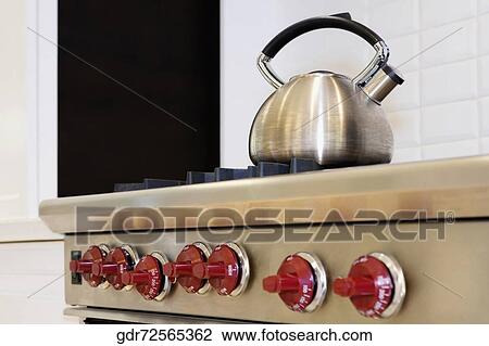 Kettle on a stove in a kitchen View Large Photo Image Stock Image - Kettle on a stove in a kitchen. Fotosearch