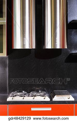 Kitchen exhaust and a gas stove in the kitchen View Large Photo Image Stock Photo - Kitchen exhaust and a gas stove in the kitchen. Fotosearch