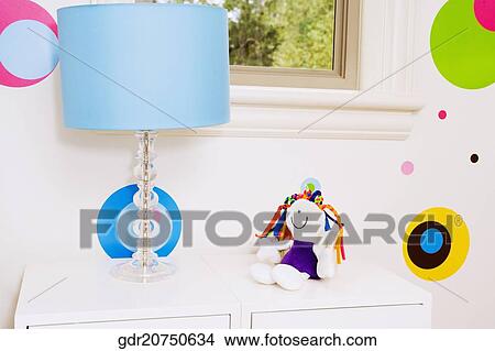 Lamp and a doll on a chest View Large Photo Image Picture - Lamp and a doll on a chest. Fotosearch