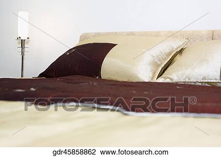 Lamp lit up beside a bed View Large Photo Image Stock Image - Lamp lit up beside a bed. Fotosearch