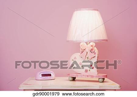 Stock Photo - Lamp lit up on a table. Fotosearch