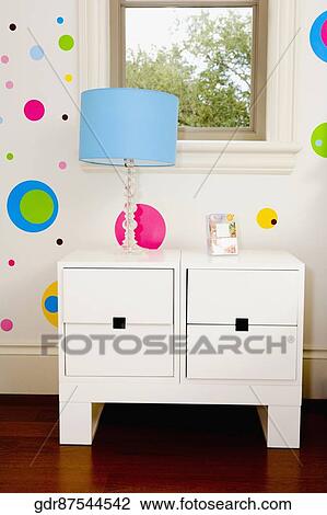 Lamp on a chest by a window View Large Photo Image Stock Image - Lamp on a chest by a window. Fotosearch