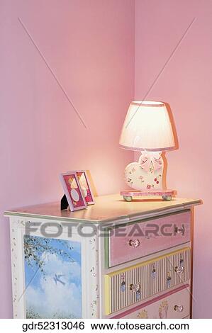 Lamp with a picture frame on a sideboard View Large Photo Image Stock Photograph - Lamp with a picture frame on a sideboard. Fotosearch