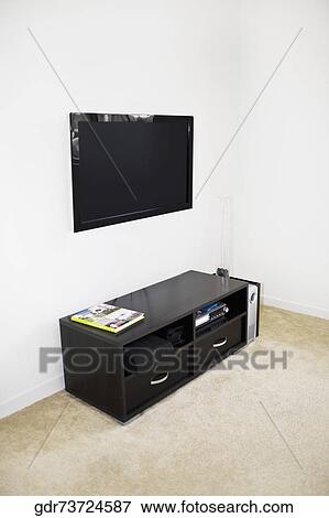 LCD television mounted on a wall View Large Photo Image Stock Photo - LCD television mounted on a wall. Fotosearch