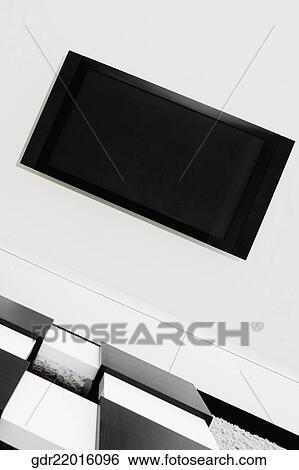 LCD television mounted on a wall View Large Photo Image Stock Photograph - LCD television mounted on a wall. Fotosearch