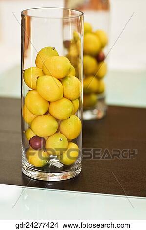 Lemons in glasses on a dining table View Large Photo Image Picture - Lemons in glasses on a dining table. Fotosearch