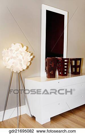 Lighting equipment lit up beside a dresser View Large Photo Image Stock Image - Lighting equipment lit up beside a dresser. Fotosearch
