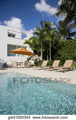 Lounge chairs at the poolside View Large Photo Image Picture - Lounge chairs at the poolside. Fotosearch