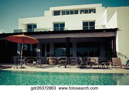 Lounge chairs at the poolside View Large Photo Image Stock Image - Lounge chairs at the poolside. Fotosearch