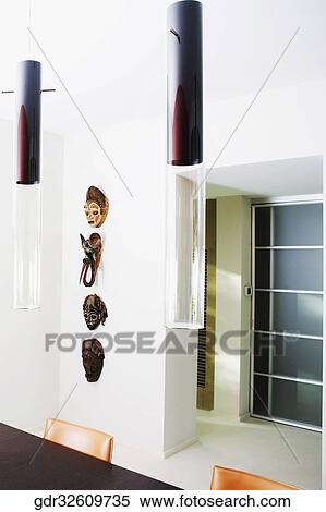 Stock Photography - Masks mounted on a wall. Fotosearch