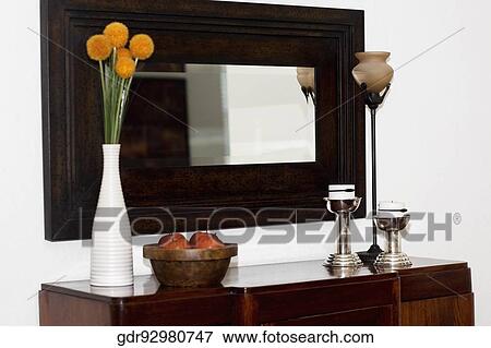 Mirror and a sideboard in a living room View Large Photo Image Stock Photo - Mirror and a sideboard in a living room. Fotosearch