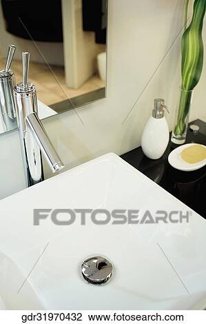 Mirror near a wash bowl on a cabinet View Large Photo Image Stock Image - Mirror near a wash bowl on a cabinet. Fotosearch