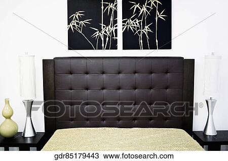 Paintings on a wall near a bed View Large Photo Image Stock Image - Paintings on a wall near a bed. Fotosearch