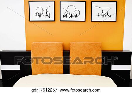 Paintings on a wall near a bed View Large Photo Image Stock Photo - Paintings on a wall near a bed. Fotosearch