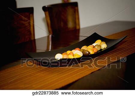 Pebbles in a tray on a table View Large Photo Image Stock Photography - Pebbles in a tray on a table. Fotosearch