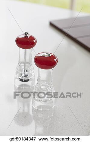 Pepper mill and a salt shaker on a kitchen counter View Large Photo Image Stock Photo - Pepper mill and a salt shaker on a kitchen counter. Fotosearch