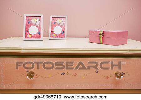 Picture frames with a box on a sideboard View Large Photo Image Stock Image - Picture frames with a box on a sideboard. Fotosearch