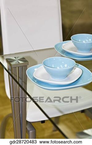 Stock Image - Porcelain setting on a dining table. Fotosearch