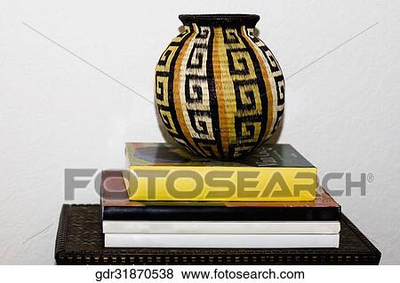 Pot on a stack of books View Large Photo Image Stock Photo - Pot on a stack of books. Fotosearch