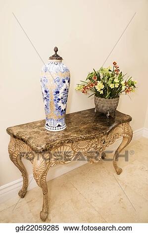 Potted plant with a jar on a table View Large Photo Image Stock Photography - Potted plant with a jar on a table. Fotosearch