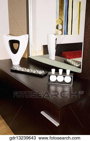 Reflection of a vase and showpieces in a mirror View Large Photo Image Stock Image - Reflection of a vase and showpieces in a mirror. Fotosearch