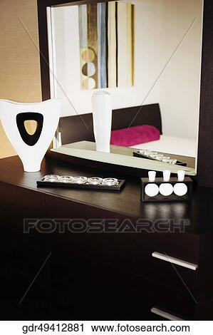 Reflection of a vase and showpieces in a mirror View Large Photo Image Stock Image - Reflection of a vase and showpieces in a mirror. Fotosearch