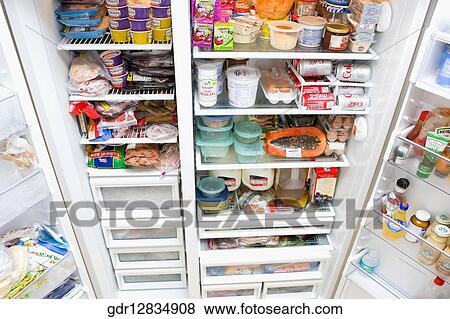 Refrigerator filled with assorted food items View Large Photo Image Stock Photo - Refrigerator filled with assorted food items. Fotosearch