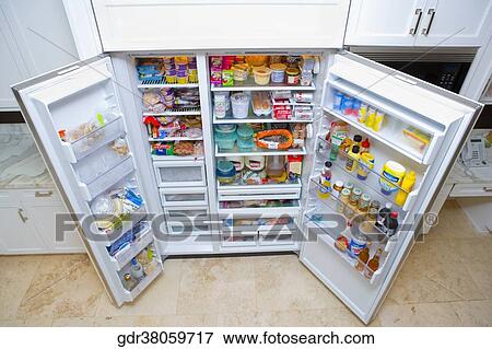 Refrigerator filled with assorted food items View Large Photo Image Stock Photo - Refrigerator filled with assorted food items. Fotosearch