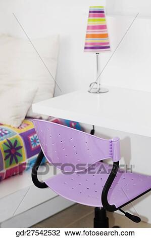 Revolving chair and a table in a bedroom View Large Photo Image Stock Image - Revolving chair and a table in a bedroom. Fotosearch