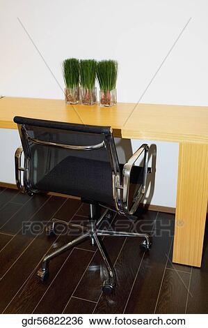 Stock Photograph - Revolving chair near a table. Fotosearch