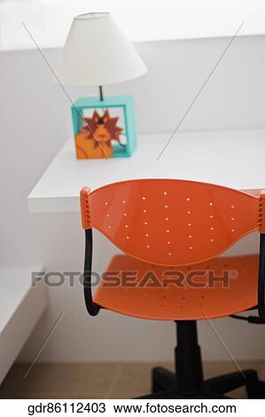Revolving chair with a table in a study room View Large Photo Image Stock Image - Revolving chair with a table in a study room. Fotosearch